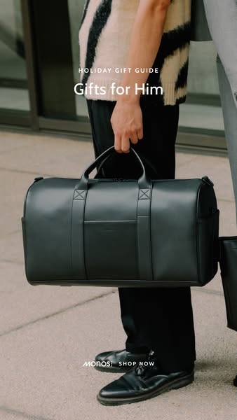 The ad features a close-up shot of a person holding a black, sleek duffel bag. The bag is the central focus, appearing modern and stylish. The text overlay 'HOLIDAY GIFT GUIDE Gifts for Him' is placed above the bag suggesting this is a gift-focused promotion, probably for the holiday season. The person holding the bag is wearing part of a patterned sweater and black pants, indicating a contemporary aesthetic. The shot is well-lit, emphasizing the bag's design.