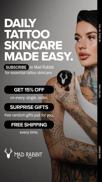 An ad with a vertical layout. The background has a gradient of gray shades. On the left, bold white text reads, “DAILY TATTOO SKINCARE MADE EASY.” Underneath, it says “SUBSCRIBE to Mad Rabbit for essential tattoo skincare.” Below this are black boxes listing offers: “GET 15% OFF on every. single. order.”, “SURPRISE GIFTS free random gifts just for you.”, and “FREE SHIPPING every time.” At the bottom, the logo is featured. On the right shows a woman with a lot of tattoos holding a jar of the product. Text in a vertical column reads “BE BOLD. BE YOU.” and “TATTOO CARE” and “MAD RABBIT”.