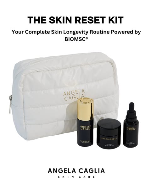 The ad showcases a white quilted cosmetic bag and three black skincare product containers, set against a bright white background. Above the bag is the title 'THE SKIN RESET KIT' in a bold, black font and also states 'Your Complete Skin Longevity Routine Powered by BIOMSC®'. The bag is centered, with the product containers lined up in front of it. The ANGELA CAGLIA brand is prominently visible both on the bag and the products. The layout is clean and focuses on the presentation of the skincare products.