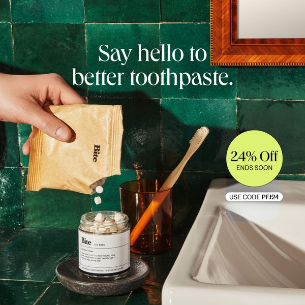 An advertisement featuring a hand pouring toothpaste tablets from a brown paper packet into a glass jar. The scene is a bathroom setting with a green tiled wall. To the right, there is a toothbrush in a brown glass and a partially visible sink. The ad copy includes the message 'Say hello to better toothpaste.' and a promotional offer of '24% Off' with the code 'PFJ24'.