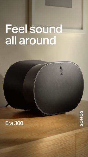 A product shot showcases the Sonos Era 300 speaker set against a neutral indoor setting. The speaker is the focal point, positioned on a wooden surface. The ad text 'Feel sound all around' is superimposed at the top, implying spatial audio capabilities. The Sonos logo is placed vertically on the right, maintaining brand consistency. The Era 300 name is also visible.