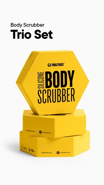 The ad features a product shot of a yellow hexagonal box labeled "SILICONE BODY SCRUBBER" stacked on top of two other yellow hexagonal boxes. The "Trio Set" product name is displayed at the top, written in a bold and modern font.