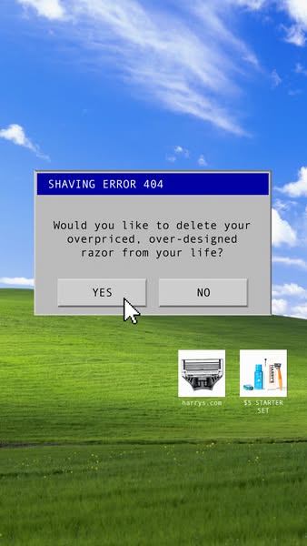 An ad featuring a humorous take on the Windows XP error screen. The background consists of the classic XP green hills and blue sky. A pop-up window reads "SHAVING ERROR 404" and asks: "Would you like to delete your overpriced, over-designed razor from your life?" with "YES" and "NO" buttons. Underneath are images of shaving products, one of the razor and another of a starter set.