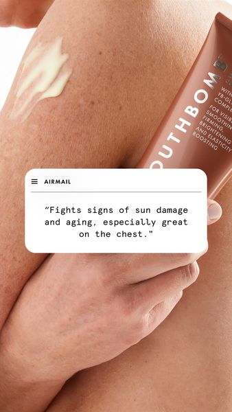 The ad features a close-up shot of a person's arm and upper chest area. A cream is applied to the arm, and a tube of cream is partially visible in the frame. A floating white speech bubble contains text that says, "Fights signs of sun damage and aging, especially great on the chest."