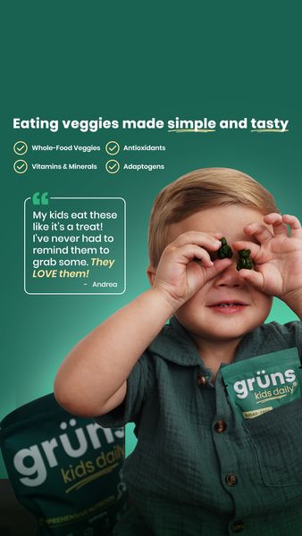 An ad features a young boy holding two gummy bear-shaped supplements in front of his eyes, with a smile on his face in the center. The ad is set on a dark green background. Above the boy is the text: "Eating veggies made simple and tasty," followed by checkmarks and bullet points listing the product's benefits: "Whole-Food Veggies", "Antioxidants", "Vitamins & Minerals", and "Adaptogens". In a speech bubble, a testimonial reads, "My kids eat these like it's a treat! I've never had to remind them to grab some. They LOVE them!" – Andrea. The boy is wearing a matching dark green shirt. In the bottom left corner of the is a bag of the product.