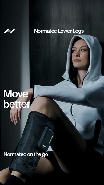 A visually appealing ad featuring a woman wearing a gray hoodie and compression leg sleeves. The woman is seated with one leg bent, showcasing the leg sleeves. The ad's background is dark, with a subtle gradient. The text layout includes "Move better" in large, prominent letters near the woman's upper body. Other text includes “Normatec Lower Legs” and “Normatec on the go”. The overall composition is modern and aims to convey a sense of wellness and recovery.
