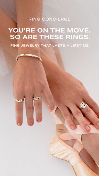 The image displays a close-up shot of a ballet dancer's hands and feet, adorned with elegant jewelry. The dancer seems to be mid-pose with their hands and feet angled delicately, showcasing a collection of rings and a bracelet. The composition highlights fine jewelry with focus on sophistication and beauty. The background consists of the tulle dress. The overall effect is elegant, refined, and artistic.