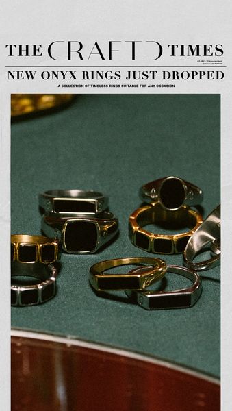 An advertisement featuring a collection of onyx rings displayed on a dark green surface. The rings are of various designs, including signet and band styles, with both silver and gold metal finishes. The layout is simple with text overlay for the campaign's key message. The image has a polished and elegant aesthetic appeal. The rings are neatly arranged, with the camera focusing on the product, highlighting the fine details and overall design.