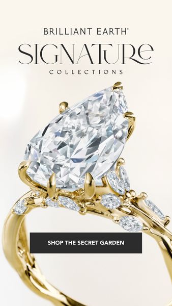 A vertical ad displaying a diamond engagement ring. The ring features a large pear-shaped diamond as the focal point, set in a gold band with smaller diamonds and decorative accents suggesting a nature-inspired design. The background is light and neutral, emphasizing the ring's sparkle and design. A call to action 'SHOP THE SECRET GARDEN' is presented in a rectangular field. The overall composition is elegant and focuses on the jewelry.