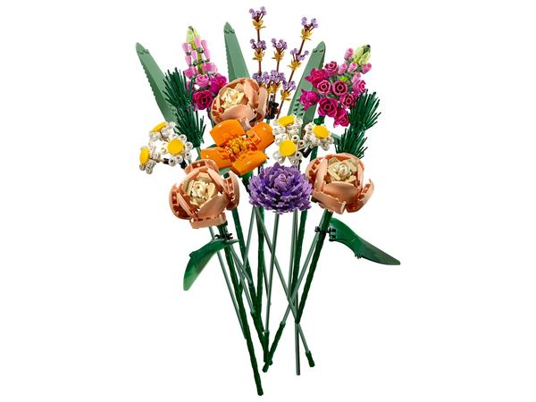 The image showcases a colorful bouquet of flowers made entirely from interlocking building blocks, set against a white background. The bouquet is diverse, featuring various flower types in shades of orange, pink, purple, and white, with green stems and leaves creating a naturalistic appearance. The flowers are arranged to resemble a real bouquet. The overall composition is clean and visually appealing.
