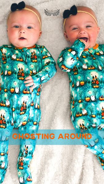 Two babies are lying on a white, fluffy blanket. They are wearing matching teal Halloween-themed onesies with pumpkin, haunted house, and ghost patterns. Both babies have black bows on their heads and are smiling. The text 'ghosting around' is in a light blue bar at the bottom.