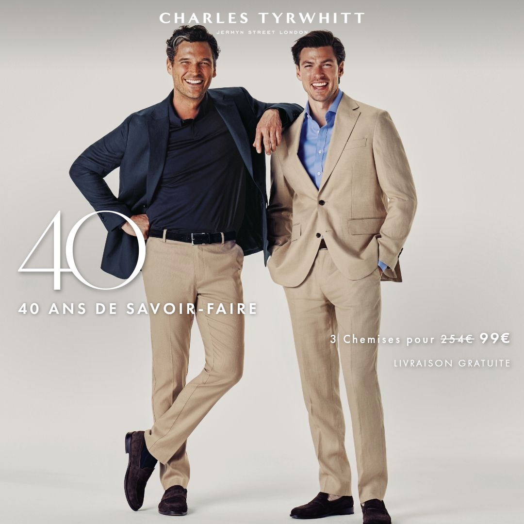 Two men in suits are standing and smiling against a plain background. The man on the left is wearing a navy blazer over a dark polo shirt and beige trousers. The man on the right is wearing a beige suit with a light blue shirt. Large white text on the left reads "40" and below it "40 ANS DE SAVOIR-FAIRE". On the right, smaller text reads "3 Chemises pour 254€ 99€" and "LIVRAISON GRATUITE". The overall impression is of a sophisticated and established brand celebrating a milestone anniversary with a special offer.