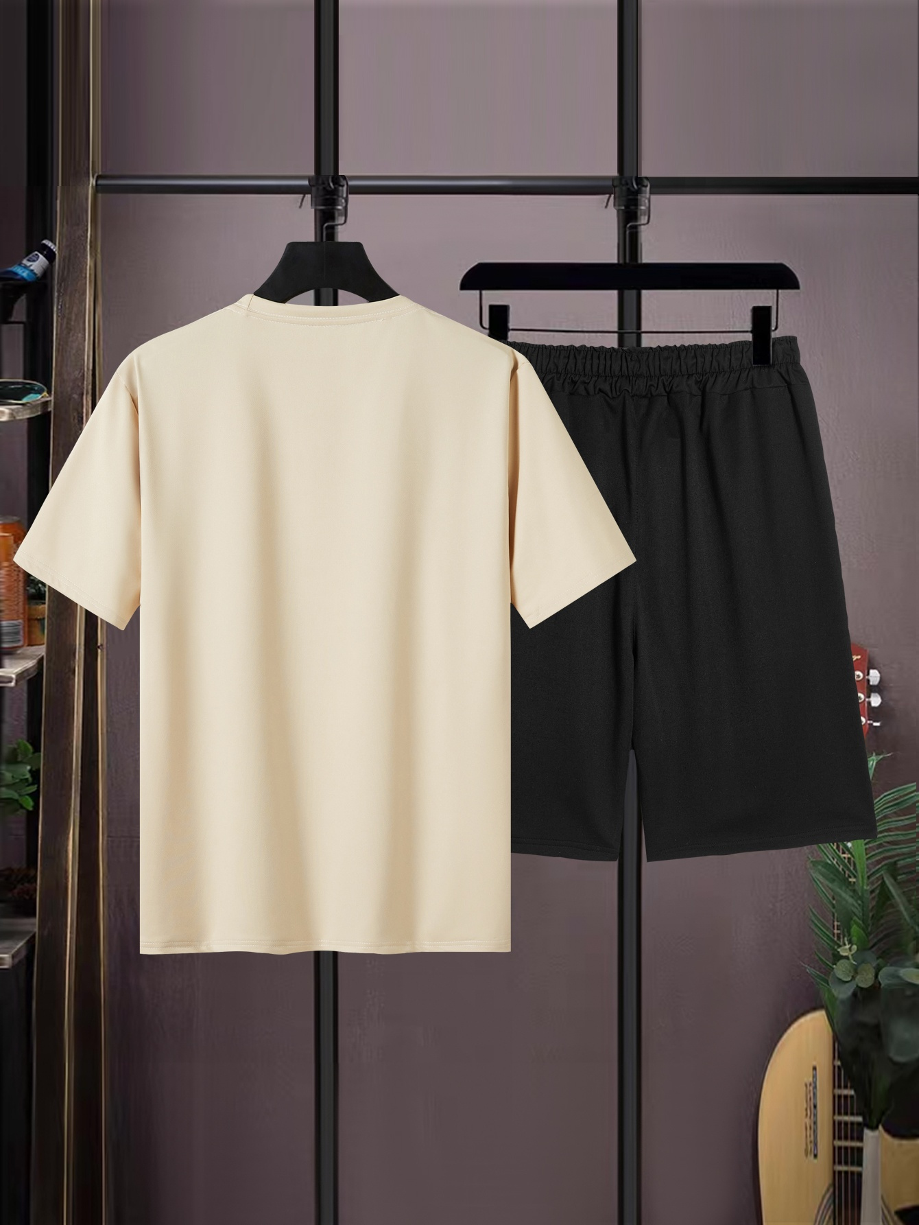 A beige t-shirt and black shorts are displayed on hangers against a dark, textured background. The image is a product shot with text overlays. The text promotes shopping on Temu, highlighting incredible offers, stress-free installments, fast shipping, and exclusive discounts. It also mentions availability for all users and encourages immediate purchase.