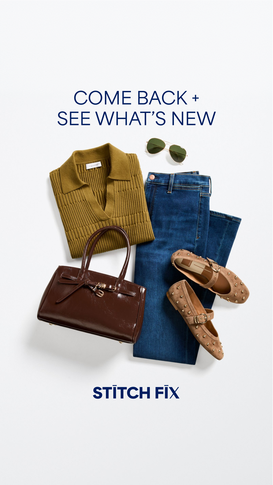 A flatlay arrangement of clothing and accessories is displayed against a white background. The items include a green ribbed collared sweater, dark wash denim jeans, a shiny brown handbag with a bow detail, and two tan studded ballet flats. A pair of aviator sunglasses rests near the sweater. The text "COME BACK + SEE WHAT'S NEW" is prominently displayed in dark blue capital letters at the top of the image. The Stitch Fix logo is visible at the bottom.