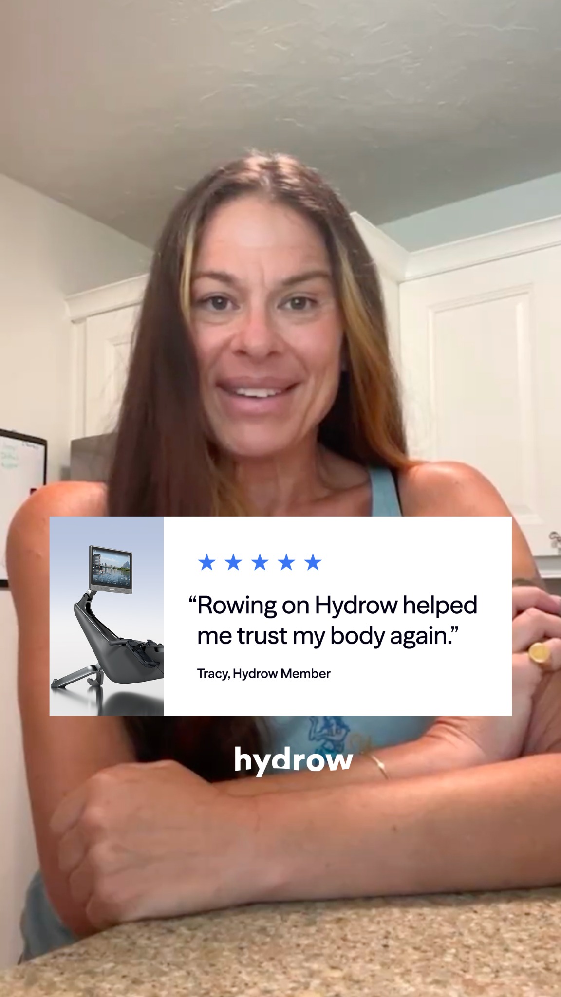 A woman is shown from the chest up, smiling at the camera. A white overlay box is in the lower left corner, featuring a Hydrow rowing machine and a five-star rating. Below the stars, a quote reads, "Rowing on Hydrow helped me trust my body again." The quote is attributed to "Tracy, Hydrow Member." The Hydrow logo is visible on a teal background in the lower center of the screen.