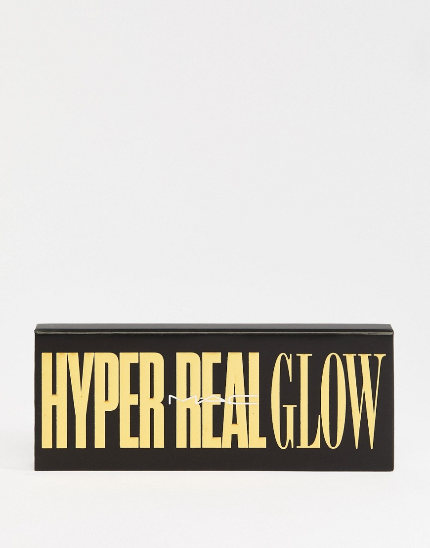 A black box with gold lettering that says "HYPER REAL GLOW" and the MAC logo in the center. The text is large and bold, with a slightly distressed texture. The background is plain white, creating a clean and minimalist look. The overall impression is one of luxury and high-quality makeup.