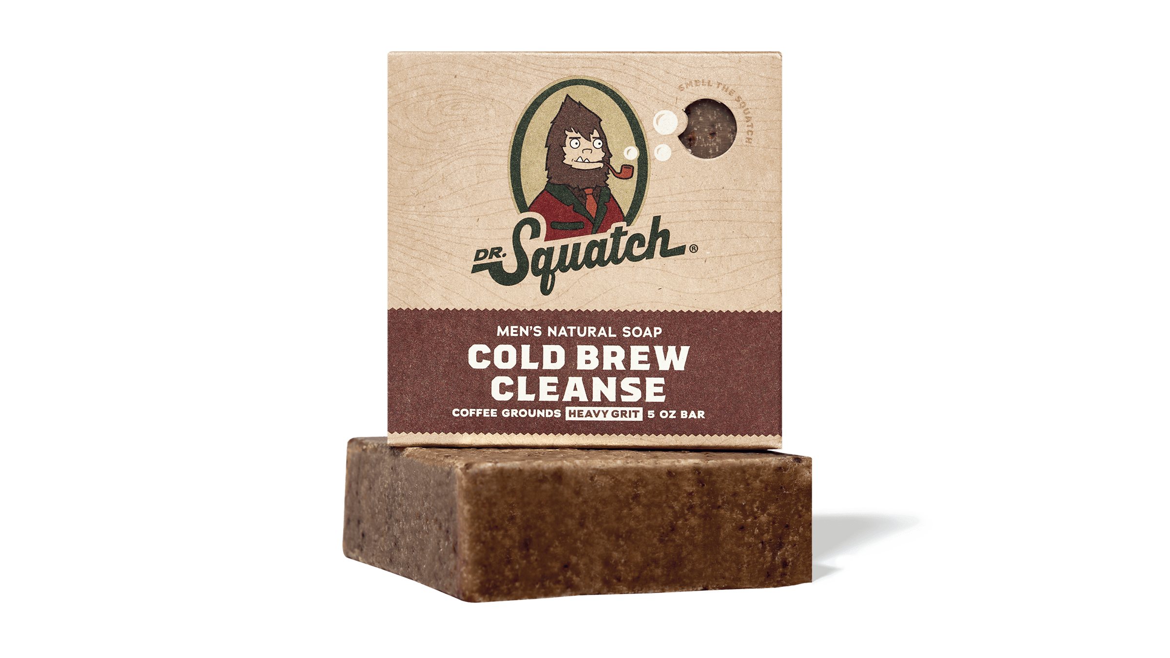 A product shot of Dr. Squatch's Cold Brew Cleanse men's natural soap bar and its packaging. The packaging features a cartoon illustration of Bigfoot smoking a pipe and the brand's logo. Text on the packaging reads 'MEN'S NATURAL SOAP', 'COLD BREW CLEANSE', 'COFFEE GROUNDS', 'HEAVY GRIT', and '5 OZ BAR'. The ad's headline, 'EXPERIENCE THE SQUATCH DIFFERENCE', is overlaid on the image, followed by three bullet points: 'The Finest Natural Ingredients', 'Formulated for Men', and 'No Harmful Ingredients'.