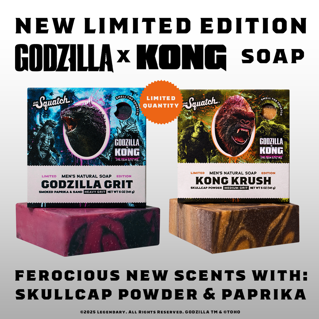 Two Dr. Squatch soap boxes, one for Godzilla Grit and one for Kong Krush, are displayed prominently. The Godzilla box is on the left, featuring Godzilla's head, and the Kong box is on the right, featuring Kong's head. Both boxes have "Limited Edition" and "Godzilla x Kong" branding. Below the boxes, the text "FEROCIOUS NEW SCENTS WITH: SKULLCAP POWDER & PAPRIKA" is displayed. The overall presentation highlights the new, limited-edition soap collaboration.