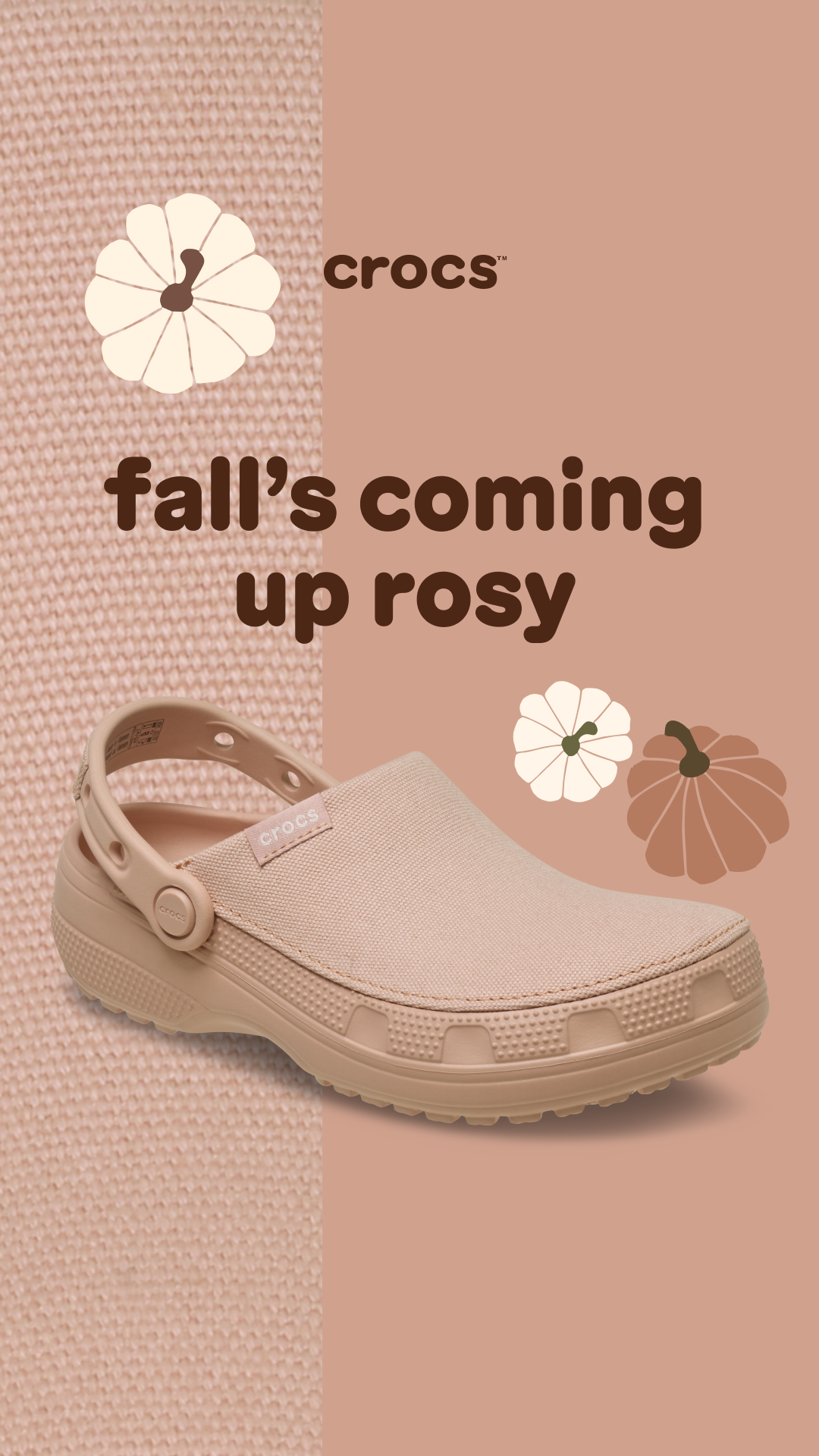 A light beige Crocs shoe is shown against a background split between a textured knit fabric and a solid muted pink. Decorative illustrations of a white and a brown pumpkin are placed near the shoe. The text "fall's coming up rosy" is displayed prominently in a dark brown font. The Crocs logo is visible on the shoe and in the upper right corner.