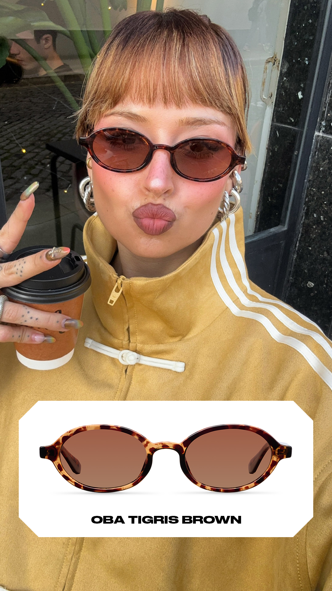 A woman wearing sunglasses and a yellow jacket is holding a coffee cup and making a kissing face. Below her, a product image of the sunglasses is displayed with the text "OBA TIGRIS BROWN" underneath. The sunglasses have a tortoiseshell frame and brown lenses.