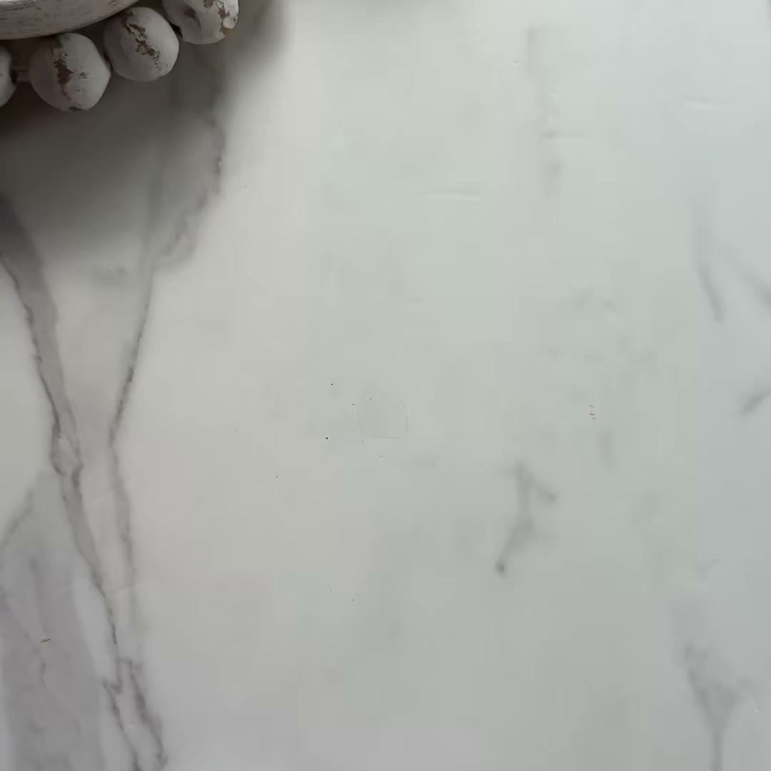 A close-up shot of a white marble surface with a decorative beaded garland in the upper left corner. The garland is made of distressed white wooden beads. The text "Coffee unleashed. High-altitude Peruvian beans, medium roasted and blended with organic Chaga, Lion’s Mane, Maitake, and Cordyceps mushrooms. Your morning cup, supercharged." is overlaid on the image. The overall aesthetic is clean and minimalist, highlighting the product's premium ingredients and benefits.