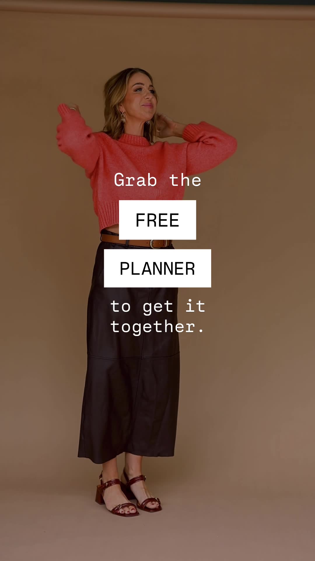 A woman in a coral sweater and black skirt stands against a neutral background. Text overlays read "Grab the FREE PLANNER to get it together." The image is a lifestyle shot with text integrated into the scene. The offer is for a free planner.