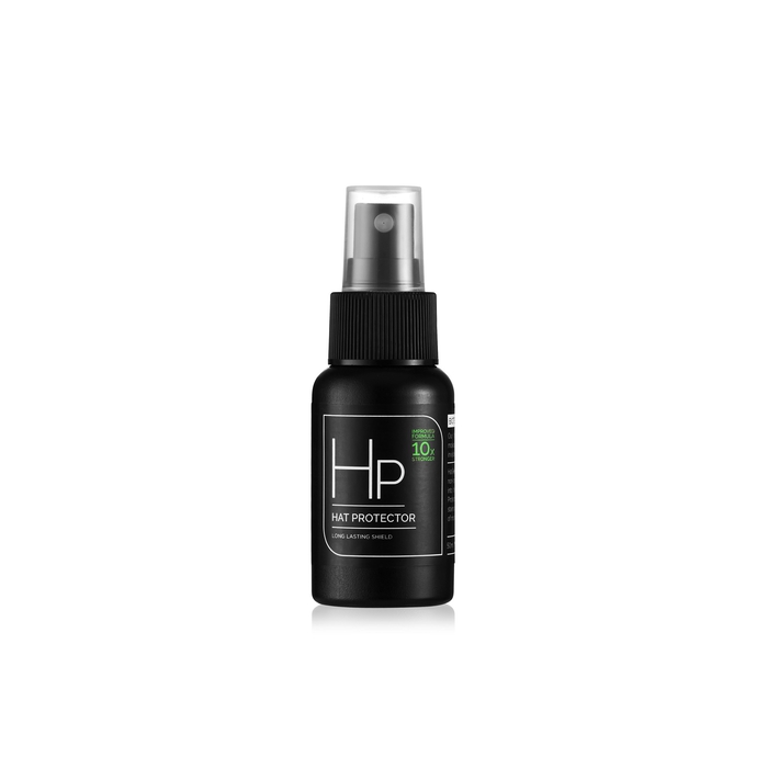 A black spray bottle of "HP HAT PROTECTOR" is shown against a white background. The label on the bottle features white text that reads "HP" in a large font, with "HAT PROTECTOR" below it. To the right of "HP", smaller green text states "IMPROVED FORMULA 10X STRONGER". Below "HAT PROTECTOR", it says "LONG LASTING SHIELD" in smaller white text. The bottle has a black ribbed cap and a clear spray nozzle.