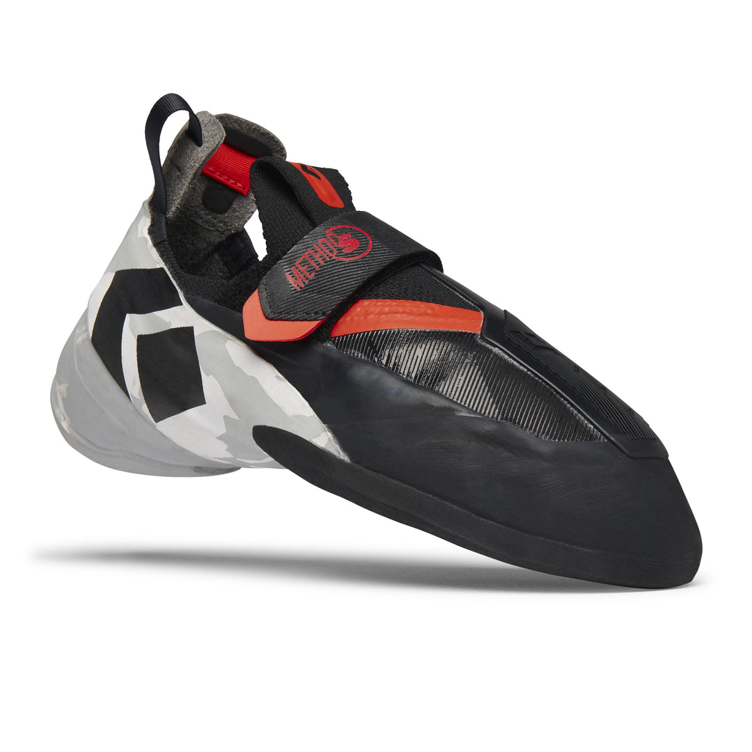 A single Black Diamond climbing shoe is shown from a side angle against a white background. The shoe is black with red and orange accents and a camouflage-patterned heel. Text overlays read "Built to perform." and "Out there. Every day."