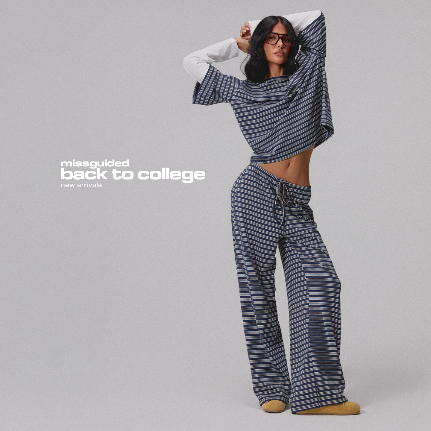 A model poses with her hands behind her head, wearing a striped long-sleeved shirt and matching wide-leg pants. The text "missguided back to college new arrivals" is overlaid on the left side of the image. The overall aesthetic suggests a focus on new clothing collections for the back-to-school season, with the model embodying a relaxed and stylish look.