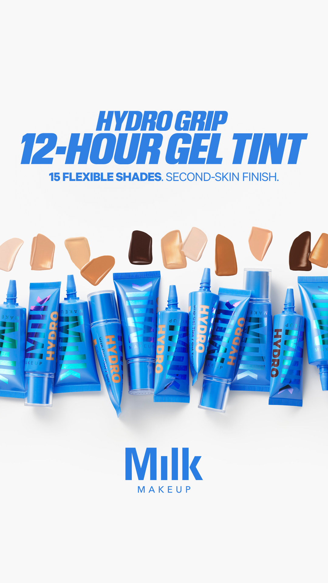 A clean, white background displays the Milk Makeup logo at the bottom. Above it, a collection of blue tubes of "Hydro Grip 12-Hour Gel Tint" are arranged. Swatches of various foundation shades are shown in a row above the tubes, demonstrating the range of colors available. The main text overlay reads "HYDRO GRIP 12-HOUR GEL TINT" in bold blue lettering, with smaller text below stating "15 FLEXIBLE SHADES. SECOND-SKIN FINISH."