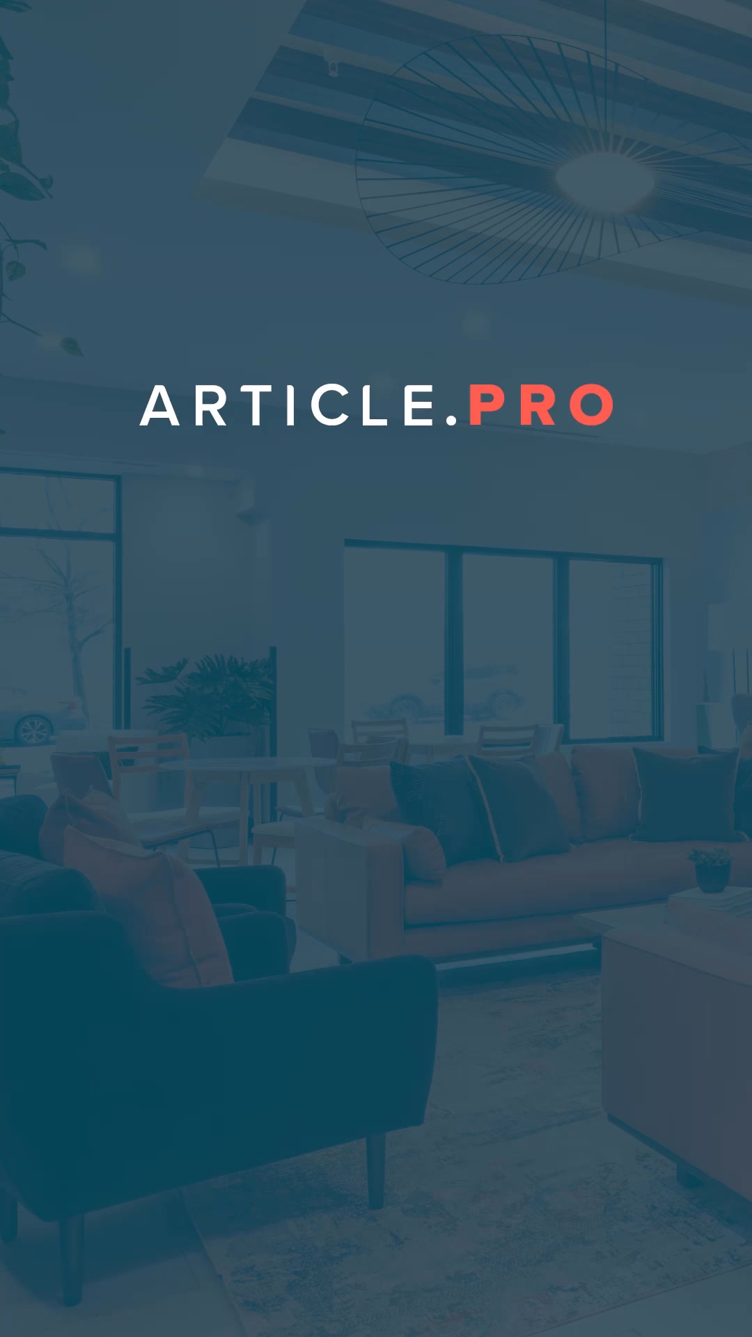 The creative features the text "ARTICLE.PRO" prominently displayed in white and red against a dark blue overlay. The background image shows a modern, well-lit interior with comfortable seating areas, suggesting a co-working space or a lounge. The text is centered, with "ARTICLE" in white and ".PRO" in red, acting as the main visual element and hook. The overall impression is professional and inviting, hinting at a service or platform related to professional content or project management.