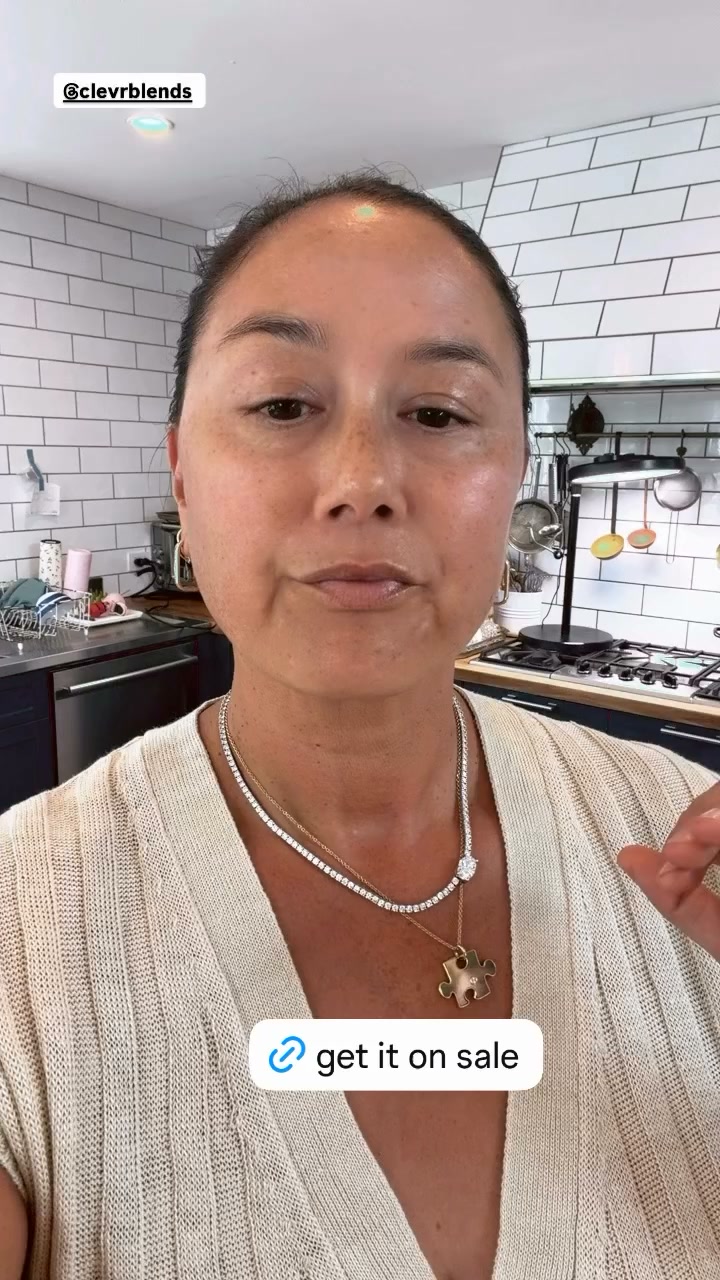 A woman with light-colored ribbed clothing and two necklaces is speaking directly to the camera in what appears to be a kitchen. A text overlay at the bottom of the screen reads "get it on sale" with a link icon. The woman has freckles and is looking slightly off-camera. The background shows kitchen cabinets and a stovetop.