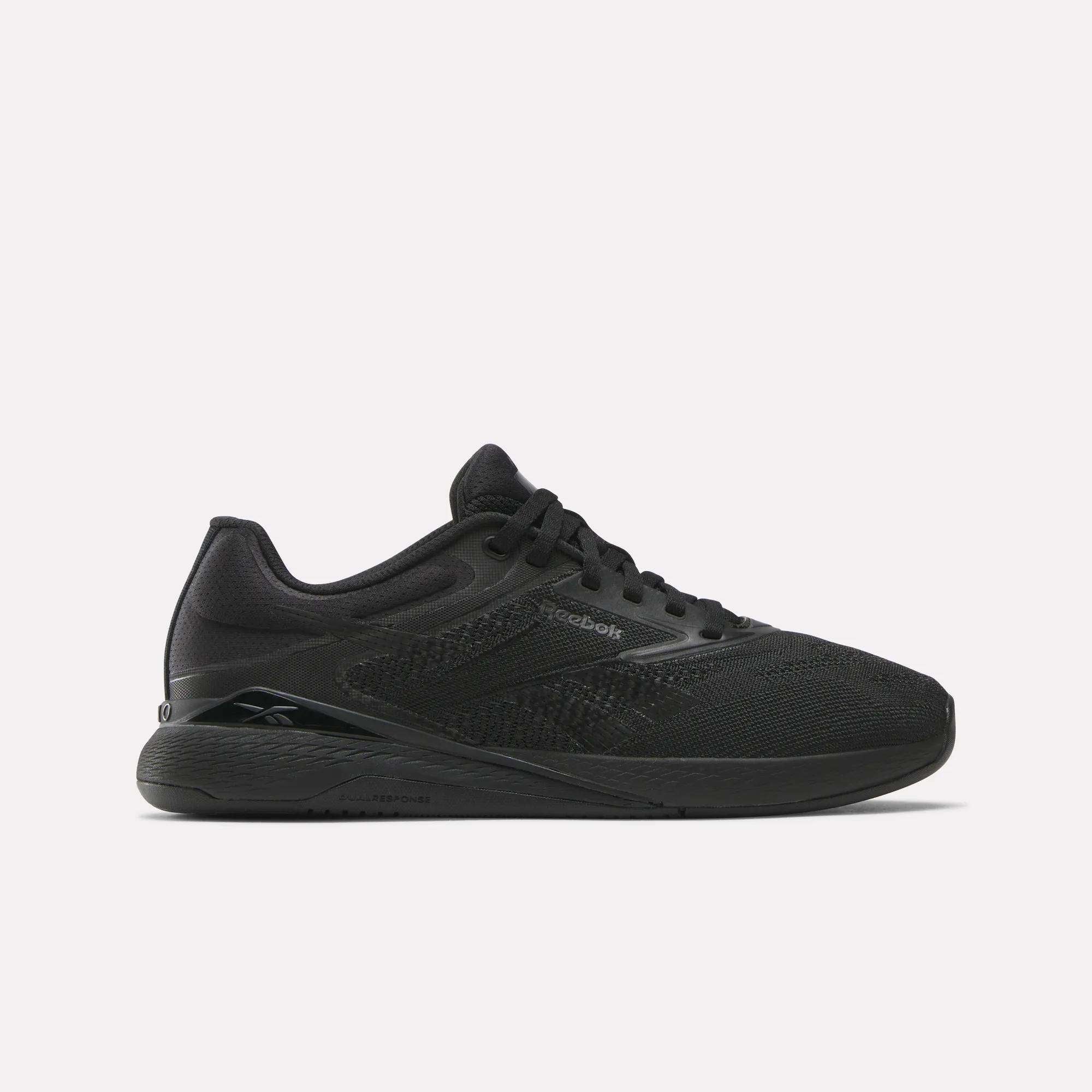 A black Reebok Nano training shoe is shown in a studio shot against a light grey background. The shoe is angled to display its side profile, with the laces tied and the Reebok logo visible on the side. Text overlaying the image reads: "Nano: Built to power every lift, jump, and sprint." The creative focuses on the product's design and intended use for athletic performance.