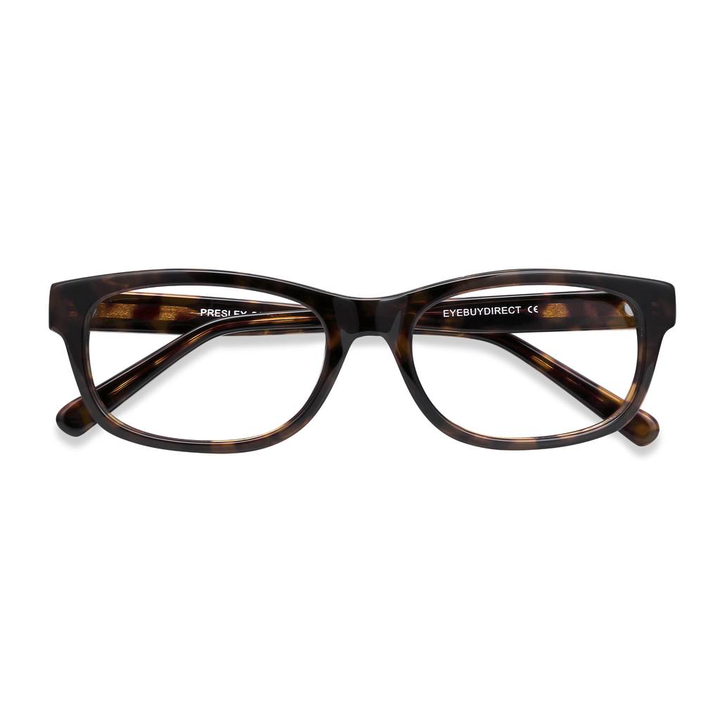 A pair of tortoiseshell eyeglasses is shown from a top-down perspective against a plain white background. The text "PRESLEY" is visible on the left temple arm, and "EYEBUYDIRECT CE" is visible on the right temple arm. The hook "On the road a lot? 🛣️" is displayed prominently at the top of the image, with the rest of the copy below it.