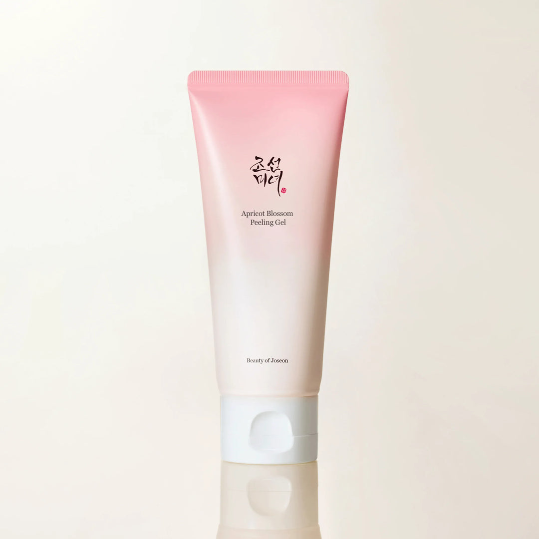 A gradient pink and white tube of Beauty of Joseon Apricot Blossom Peeling Gel is centered against a neutral, reflective background. The brand name and product title are clearly visible on the tube. The text overlay highlights a 20% discount on the first order, expert beauty tips, and exclusive subscriber benefits, encouraging immediate subscription.