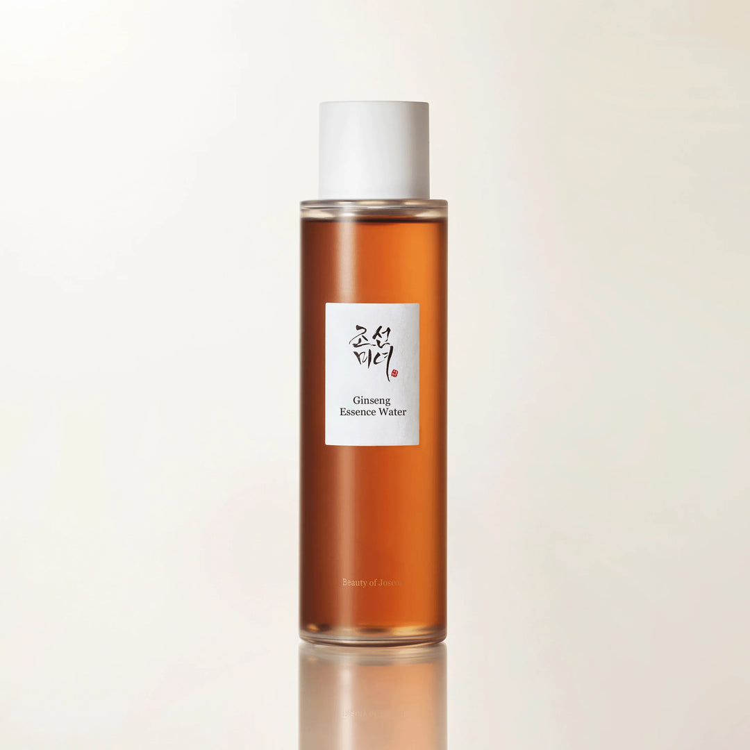 A product shot of a bottle of Beauty of Joseon Ginseng Essence Water against a clean, light background. The bottle is amber-colored with a white cap and a label featuring Korean text and "Ginseng Essence Water" in English. The text "Beauty of Joseon" is visible at the bottom of the bottle. The copy introduces the brand's philosophy, emphasizing skincare as a ritual rooted in history, care, and connection.