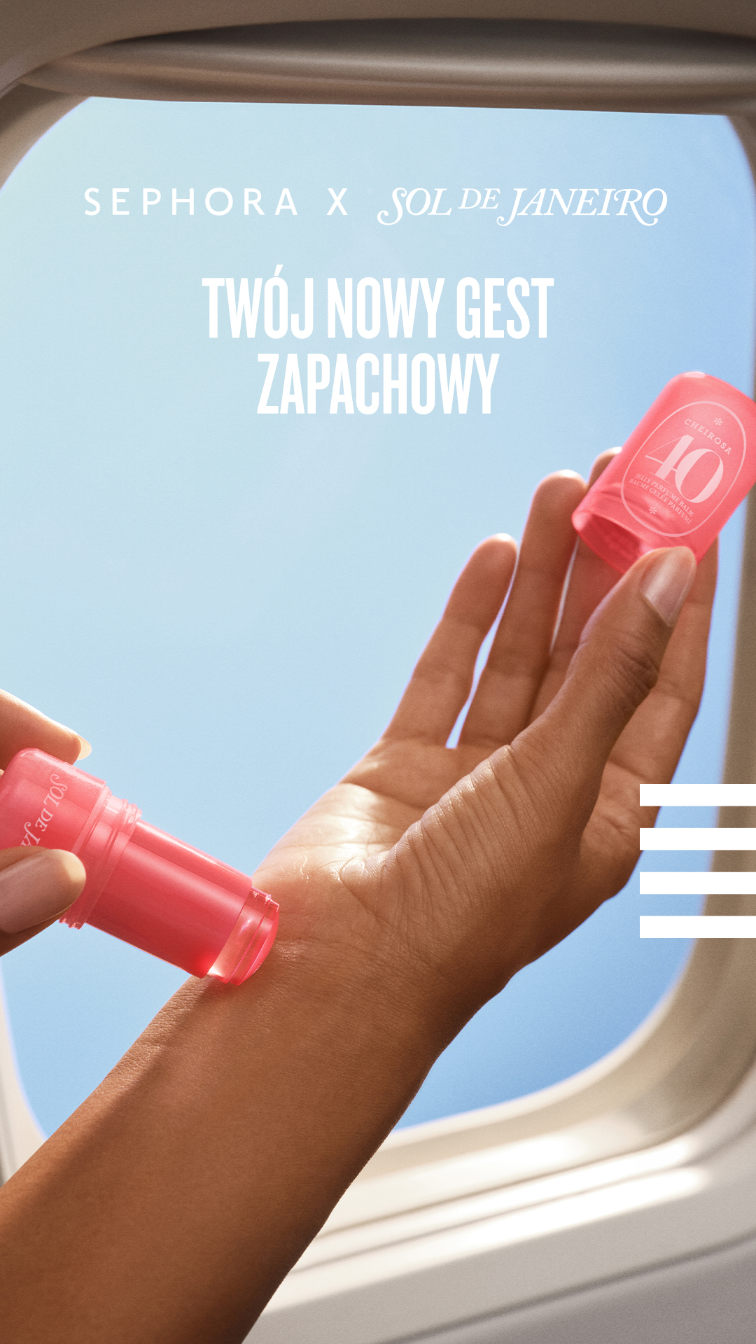A close-up shot shows a person's hand holding a small, pink, cylindrical perfume balm and applying it to their wrist. The background is a bright blue sky, suggesting travel or an open-air setting, possibly from inside an airplane window. White text overlaid on the image reads "SEPHORA X SOL DE JANEIRO" and "TWÓJ NOWY GEST ZAPACHOWY," which translates to "YOUR NEW FRAGRANCE GESTURE."