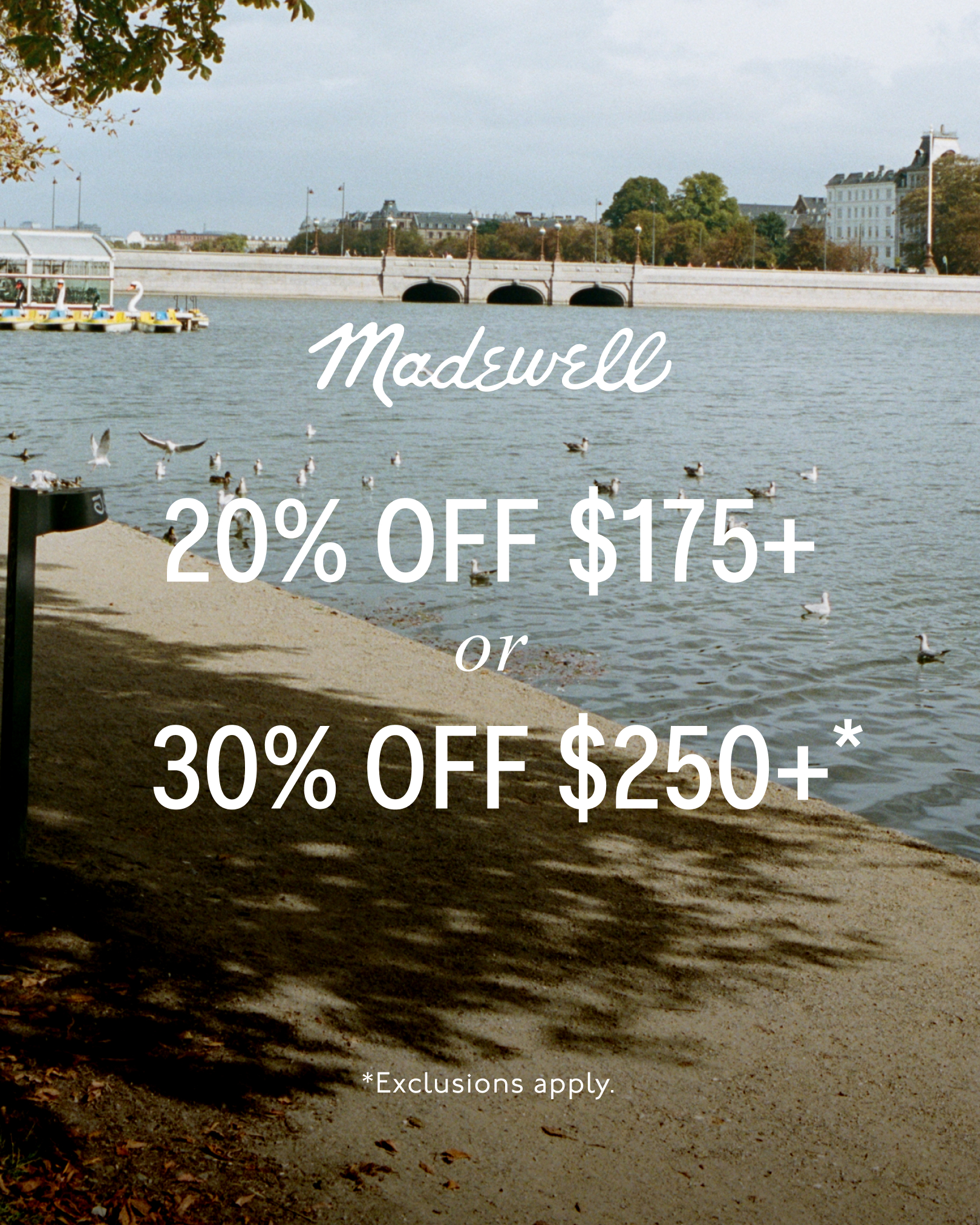 A serene outdoor scene depicts a body of water with boats and birds, set against a backdrop of buildings and a bridge. The Madewell logo is prominently displayed. Overlayed text announces a limited-time offer: "20% OFF $175+ or 30% OFF $250+*" with smaller text at the bottom stating "*Exclusions apply."