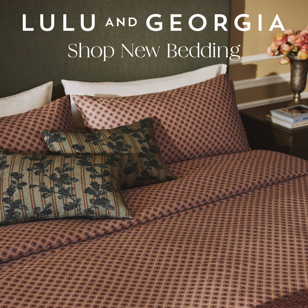 A beautifully made bed with patterned bedding and decorative pillows is shown. The brand name "LULU AND GEORGIA" is displayed prominently at the top of the image, followed by the text "Shop New Bedding." The copy "This is your sign to refresh your bedding." is overlaid on the image, directly addressing the viewer and encouraging them to consider updating their bedding.