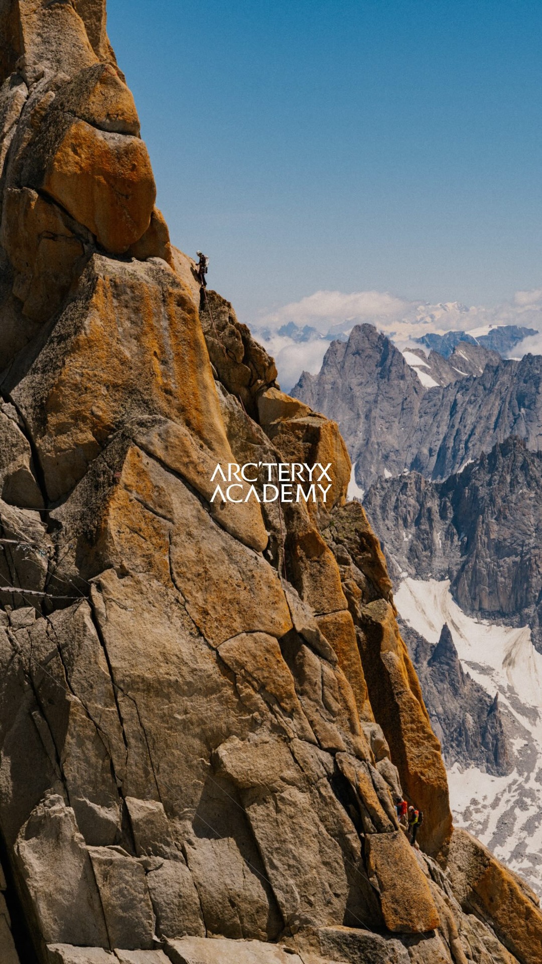 A dramatic, sun-drenched mountain landscape with a climber ascending a steep, rocky face. The climber is small in the frame, emphasizing the vastness of the environment. The text "ARC'TERYX ACADEMY" is overlaid in white, centered on the image. The scene conveys a sense of adventure and challenge in a remote, natural setting.