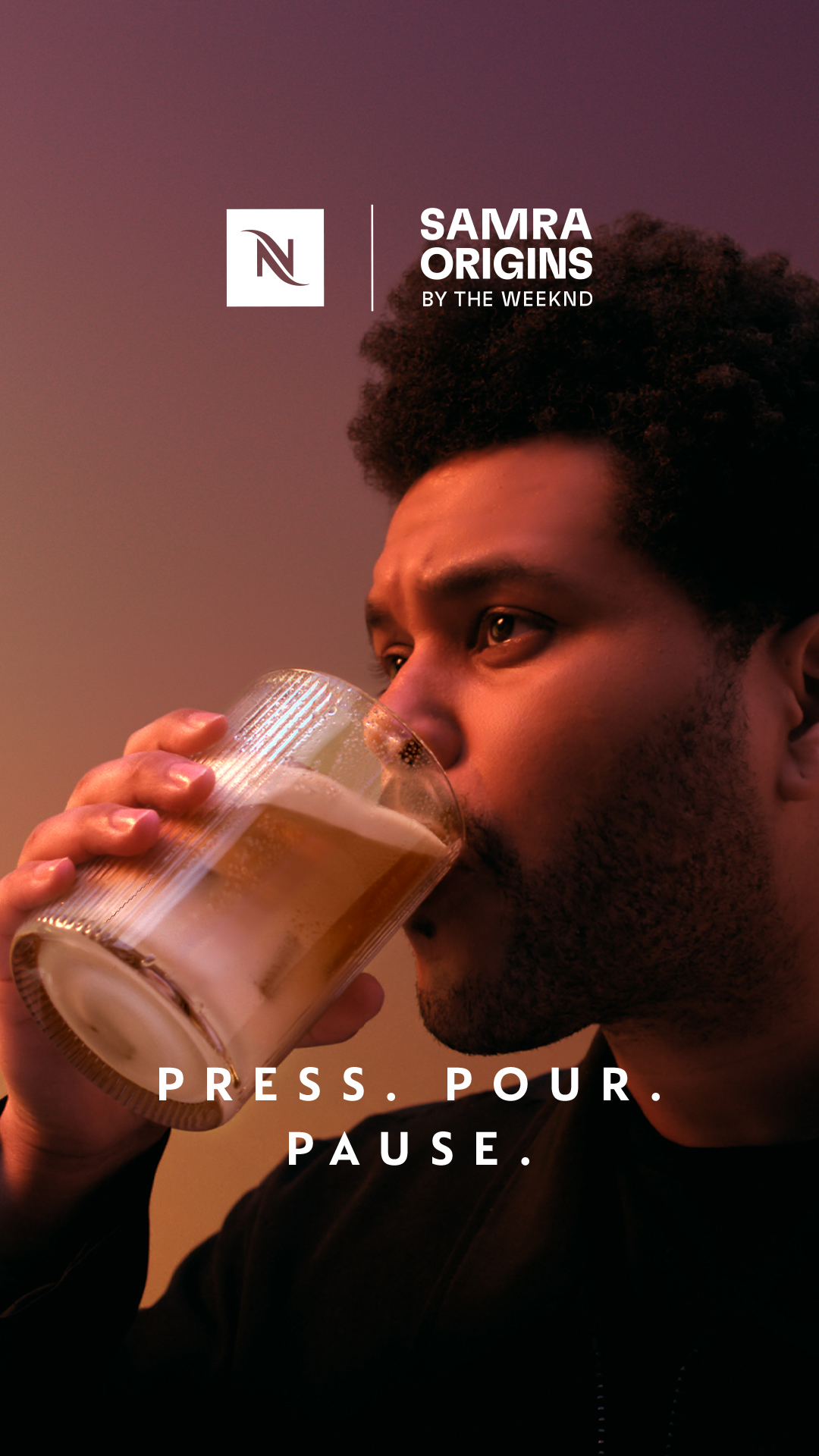 A close-up shot shows a man with dark skin and curly hair drinking from a glass. The Nespresso logo and "SAMRA ORIGINS BY THE WEEKND" are visible in the upper left corner. White text overlays the bottom of the image, reading "PRESS. POUR. PAUSE." The overall mood is sophisticated and relaxed, with warm lighting.