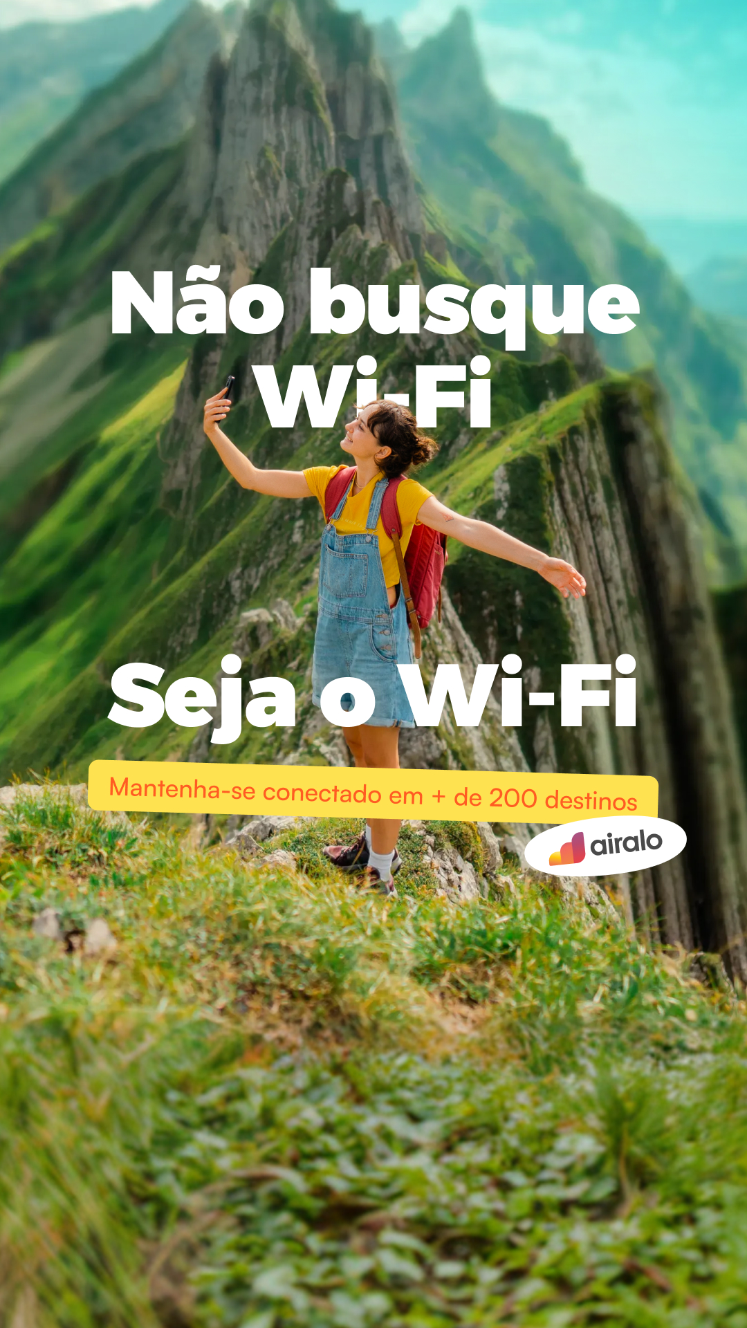 A woman stands on a mountain peak, holding her phone up as if taking a selfie, with a vast, green mountain range behind her. Large white text overlays the image, reading "Não busque Wi-Fi" (Don't look for Wi-Fi) and below that, "Seja o Wi-Fi" (Be the Wi-Fi). A yellow banner at the bottom states "Mantenha-se conectado em + de 200 destinos" (Stay connected in + 200 destinations), with the Airalo logo to its right.