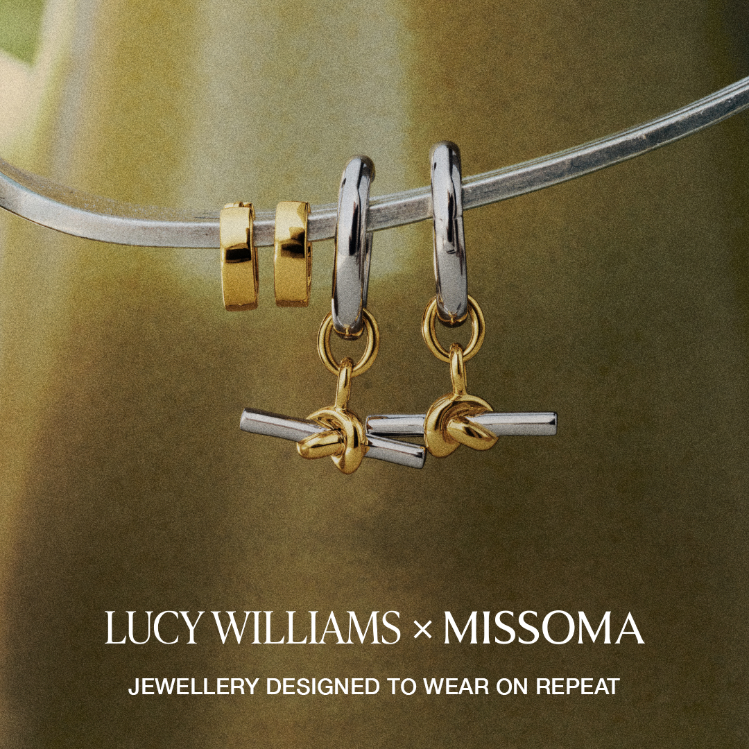 The creative showcases a collection of earrings, featuring a mix of gold and silver tones, artfully arranged on a metallic bar against a softly blurred, warm-toned background. The text "LUCY WILLIAMS × MISSOMA" is prominently displayed in a sophisticated font, followed by the tagline "JEWELLERY DESIGNED TO WEAR ON REPEAT" in a smaller, complementary font. The overall aesthetic is minimalist and elegant, highlighting the intricate design of the jewelry.
