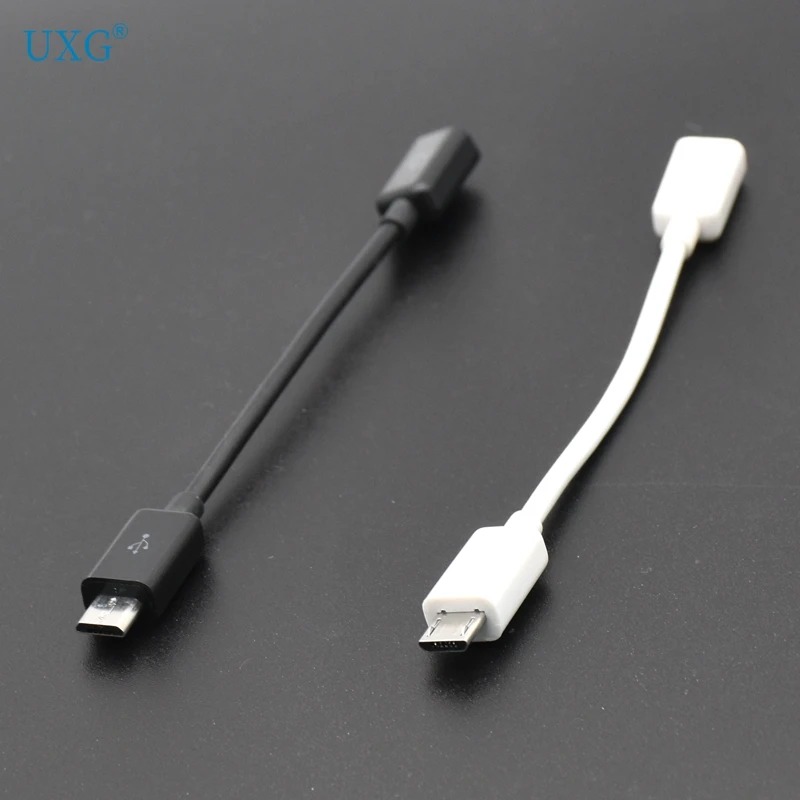 The image displays two USB adapter cables, one black and one white, lying on a dark, reflective surface. The black cable has a USB-A connector on one end and a Micro USB connector on the other. The white cable has a USB-A connector on one end and a USB-C connector on the other. The text "UXG®" is visible in the upper left corner of the image. The ad copy, which is not part of the visual, highlights a $3 new user coupon for orders of $4 or more, emphasizing the availability of millions of products worldwide.