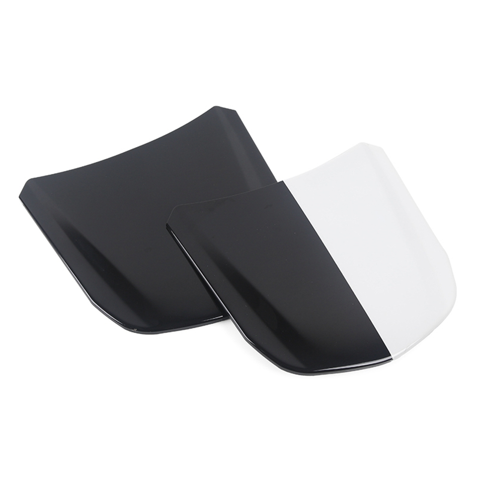 The image displays two automotive hood scoops, one entirely black and the other split diagonally between black and white. They are positioned at an angle against a plain white background, with the black scoop slightly behind and to the left of the bi-colored scoop. The lighting highlights the glossy finish of the scoops. There is no text visible on the creative itself.