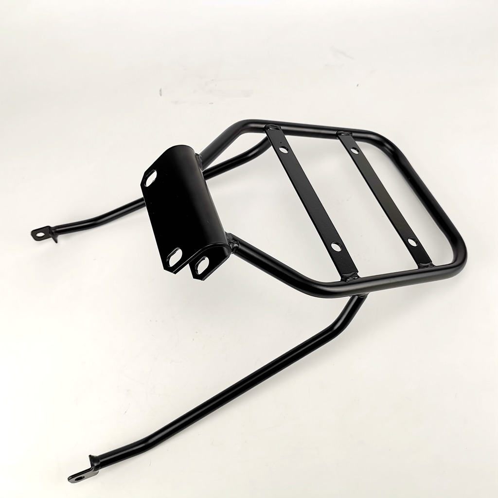 A black metal motorcycle luggage rack is shown against a white background. The rack has a flat top with three parallel bars and a mounting bracket on the side with two holes. The rack is designed to be attached to the rear of a motorcycle to carry cargo. There is no text or offer visible on the creative itself.