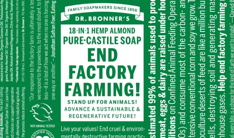 The creative is a green background with white text. The text is large and bold, with the main message being "END FACTORY FARMING!". Below this, it says "STAND UP FOR ANIMALS! ADVANCE A SUSTAINABLE & REGENERATIVE FUTURE!". To the right of the main text, there is a statistic about the percentage of animals raised in horrific conditions and the environmental impact of their feed. The bottom of the creative includes the Dr. Bronner's logo and a statement about living your values and ending destructive farming practices.