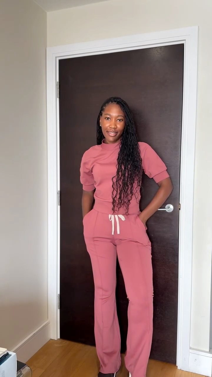 A woman wearing a rosewood-colored scrub set stands with her hands in her pockets in front of a dark brown door. The text overlay highlights the new FIGS Form X collection, describing it as ultra-sleek, ultra-stretchy, and ultra-soft, perfect for an autumn wardrobe upgrade. It mentions the new colors, Rosewood and Alder, and includes a discount code for 15% off the first order.