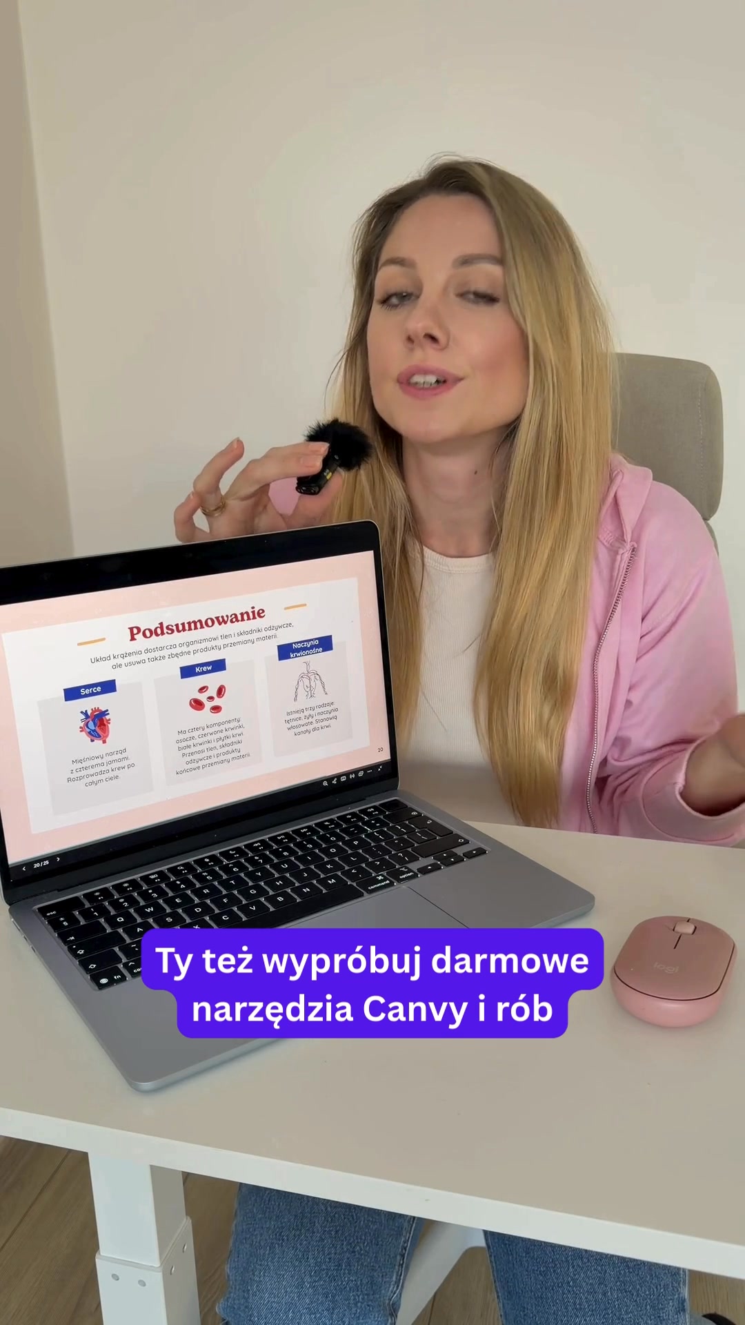 A woman with blonde hair, wearing a pink hoodie, is speaking into a microphone while looking at a laptop. The laptop screen displays a presentation slide with Polish text and diagrams of the heart, blood, and blood vessels. Overlayed on the bottom of the laptop screen is a purple banner with Polish text that reads "Ty też wypróbuj darmowe narzędzia Canvy i rób". The overall scene suggests an educational or tutorial context.