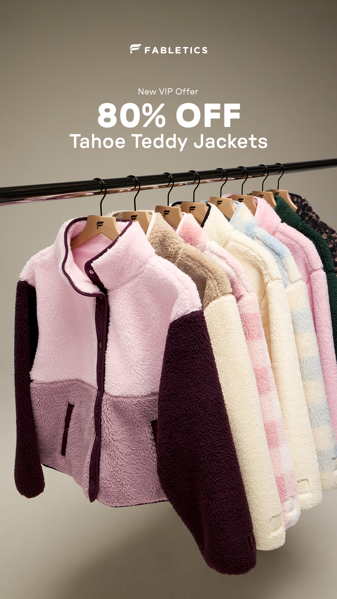A row of colorful, fluffy teddy jackets hangs on a clothing rack. The Fabletics logo is at the top, with text overlaying the image. The text announces a "New VIP Offer" and highlights "80% OFF Tahoe Teddy Jackets." The jackets are shown in various pastel colors and patterns, with the first jacket in the foreground featuring a pink and purple color block design.